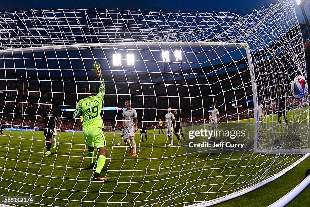 Sheyi Ojo of Liverpool FC scores against Becker Alisson of AS Roma during a friendly match at Busch Stadium on August 1, 2016 in St Louis, Missouri.