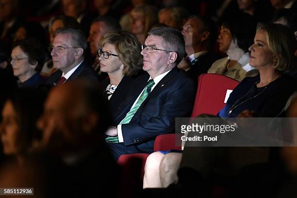 Former International Olympic Committee President Jacques Rogge and International Olympic Committee President Thomas Bach listen as President of the...
