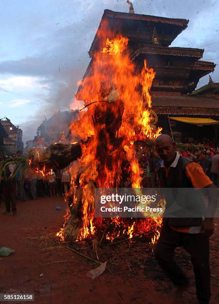 Locals set fire on an effigy of demon during the celebration of Ghantakarna festival in Bhaktapur, Nepal. Ghantakarna festival is celebrated in...