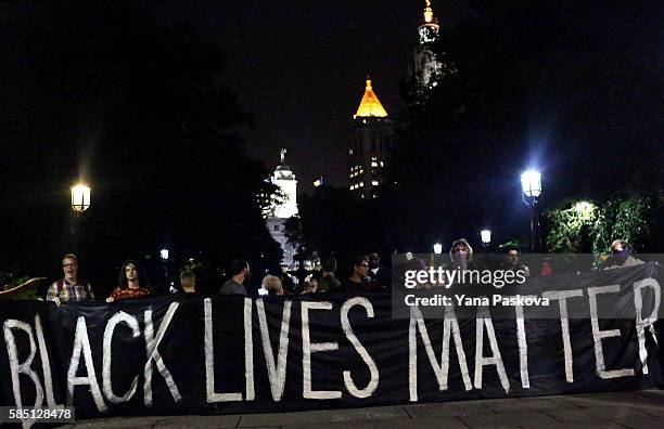 Activists participate in an anti-police brutality protest in City Hall Park in New York City on August 01, 2016. The protest was organized by...