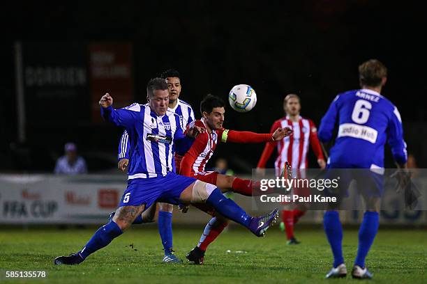 Bobby Wilson of Floreat Athena and Bruno Fornaroli of Melbourne City contest for the ball during the FFA Cup Round of 32 match between Floreat Athena...