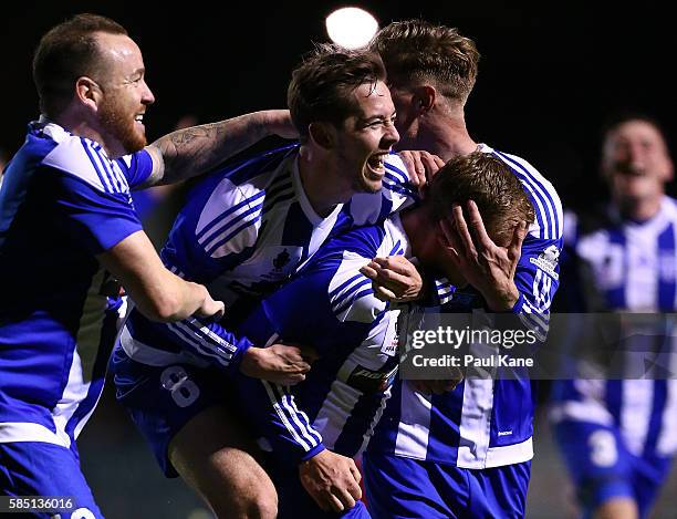 Kris Gate of Floreat Athena is congatulated by team mates after scoring a goal during the FFA Cup Round of 32 match between Floreat Athena and...