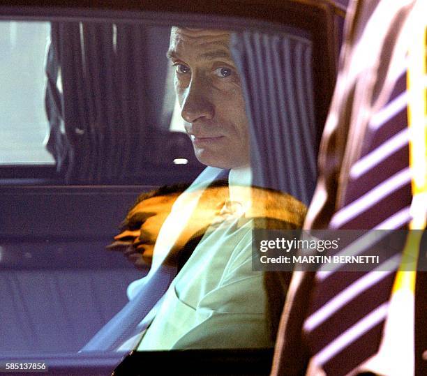 Russia's President Vladimir Putin waits inside an official car upon his arrival at Santiago's airport, 19 November 2004. Putin will attend the APEC...