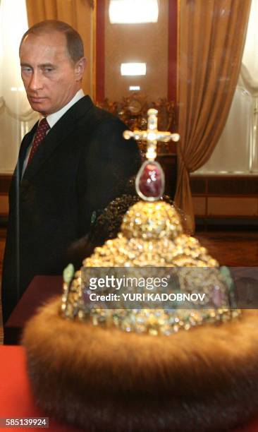 Russian President Vladimir Putin looks at the crown of Peter the Great during the ceremony of the celebration of the 200th anniversary of the Kremlin...