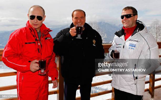 Russia's outgoing President Dmitry Medvedev and newly elected president Vladimir Putin meet with former Italy's Prime minister Silvio Berlusconi at...