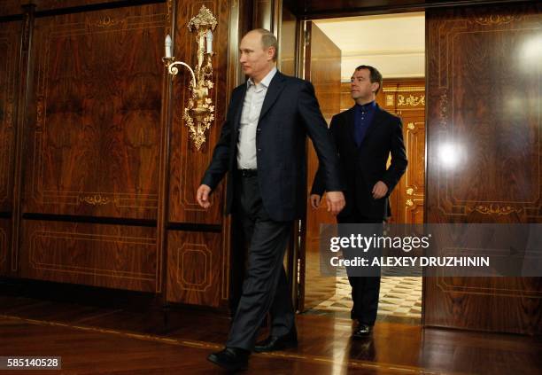 Russia's outgoing President Dmitry Medvedev and newly elected president Vladimir Putin visit the Rosa Khutor apline ski resort in Krasnaya Polyana,...