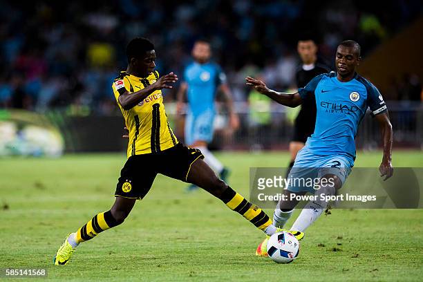 Borussia Dortmund striker Ousmane Dembele trips up with Manchester City midfielder Fernandinho Roza during the 2016 International Champions Cup China...