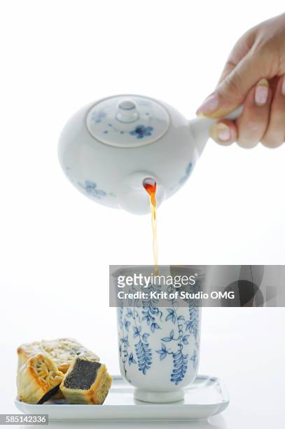 pouring the tea into cup - chinese porcelain stock pictures, royalty-free photos & images