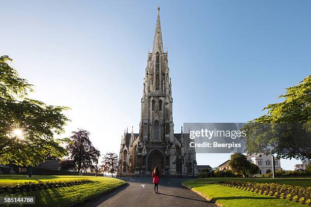 alone woman at the first church of otago in dunedin, new zealand. - dunedin stock pictures, royalty-free photos & images