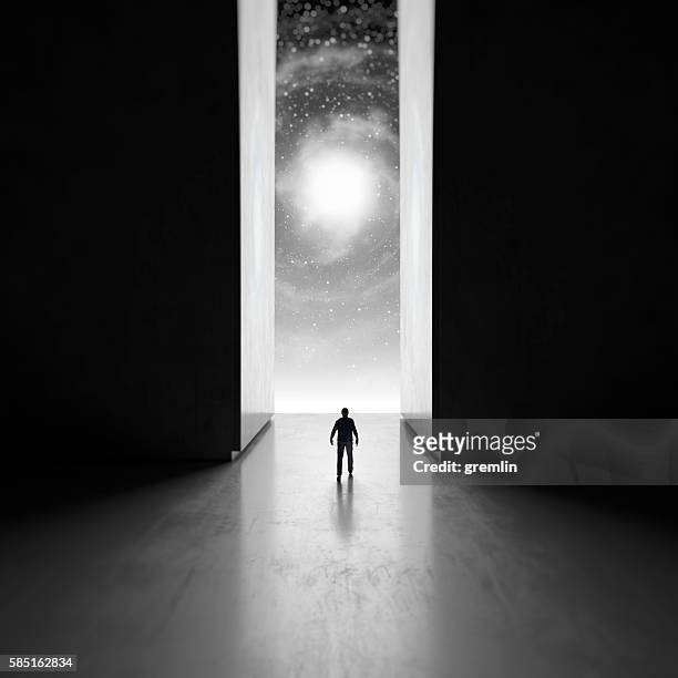 man walking through interdimensional passage - spiritual journey stock pictures, royalty-free photos & images