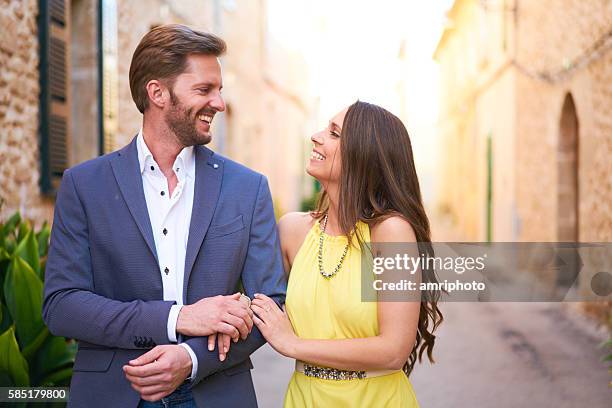 happy young woman and man walking in town - välklädd bildbanksfoton och bilder