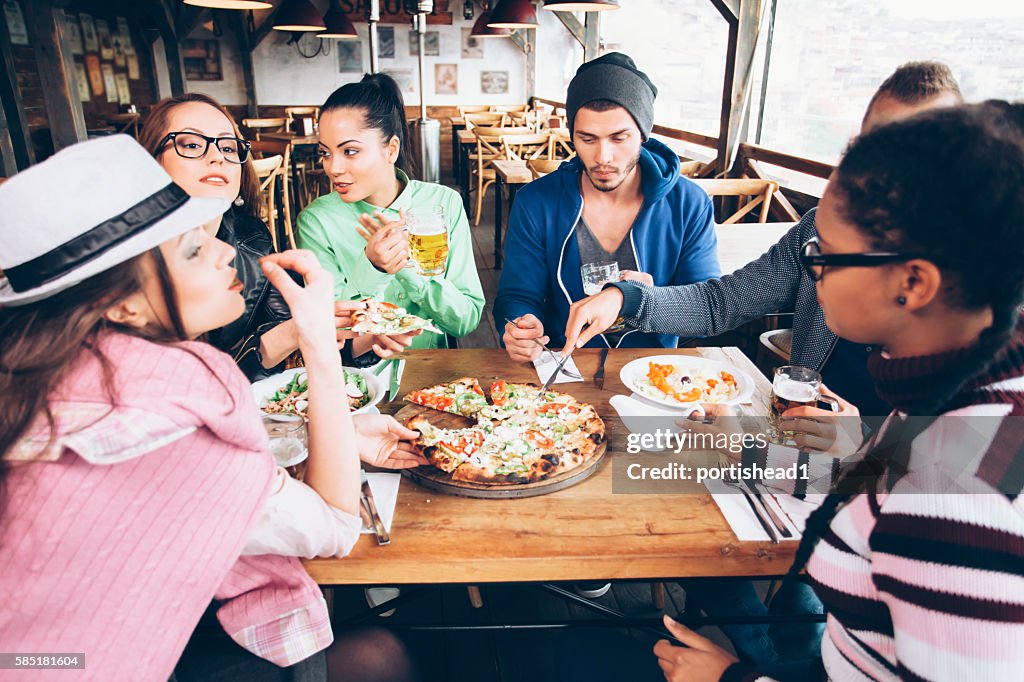 Young people dining together in a restaurant