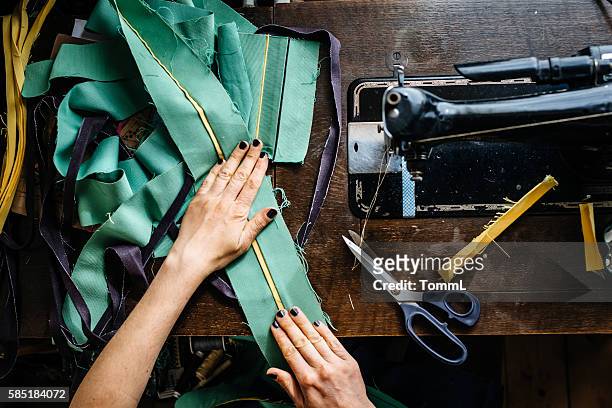 hands of a woman sewing fabrics - stitch bildbanksfoton och bilder