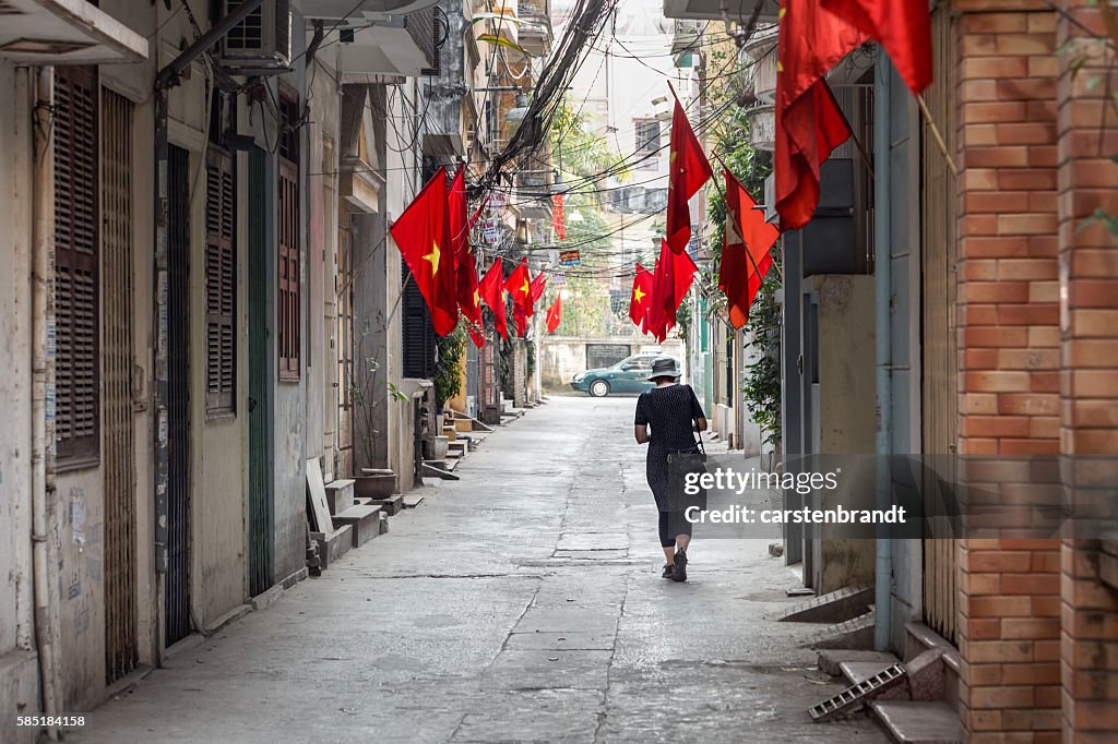 Tourist in a street  with flags and cables