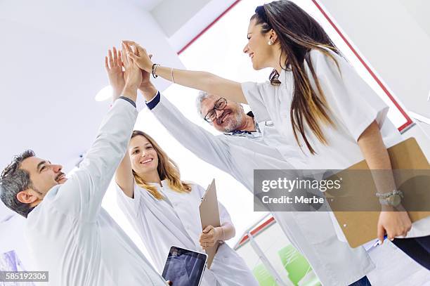 teamwork doing high-five - bone scan stock pictures, royalty-free photos & images