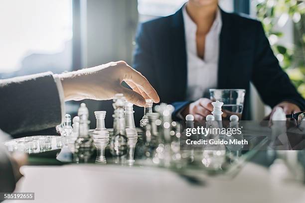 business women playing chess. - risk stock-fotos und bilder
