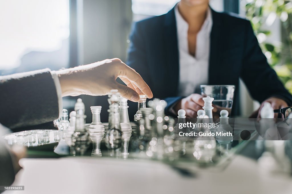 Business women playing chess.