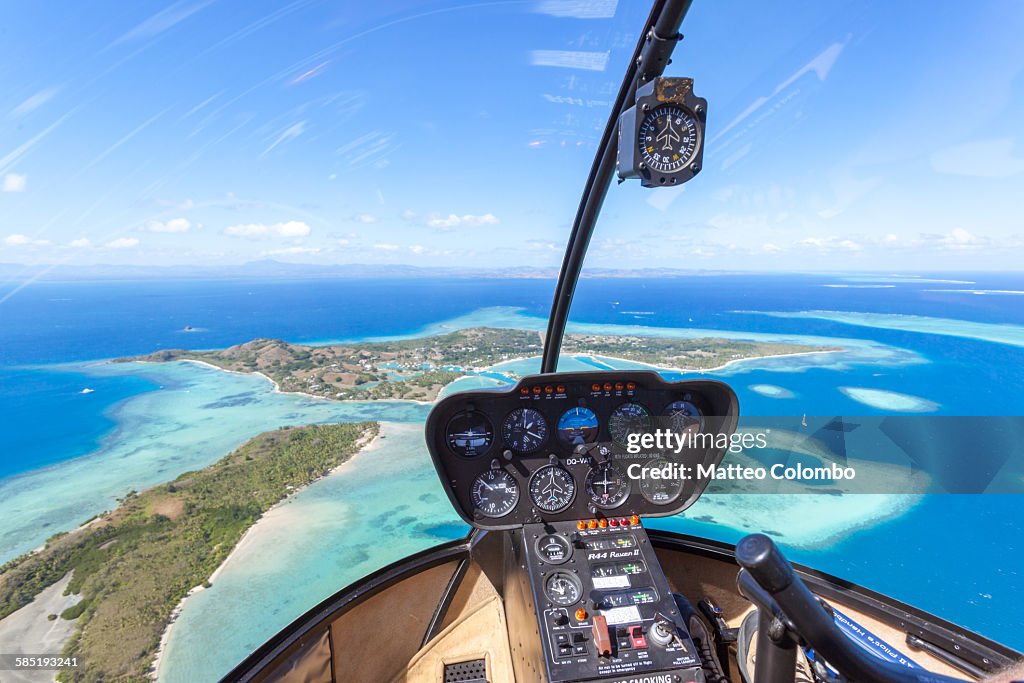 Tropical island seen from helicopter cockpit, Fiji