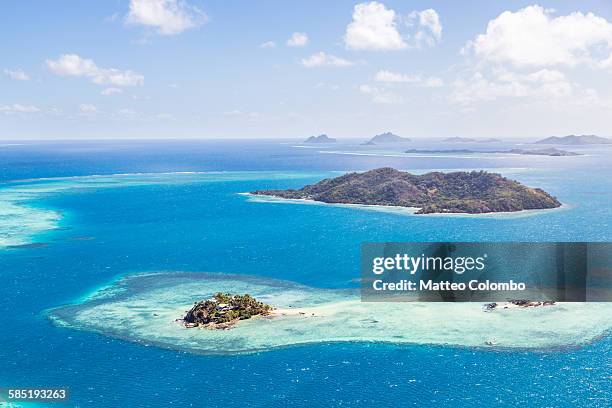 aerial of island with tourist resort, fiji - fiji stockfoto's en -beelden