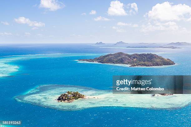 aerial of island with tourist resort, fiji - fiji stock pictures, royalty-free photos & images