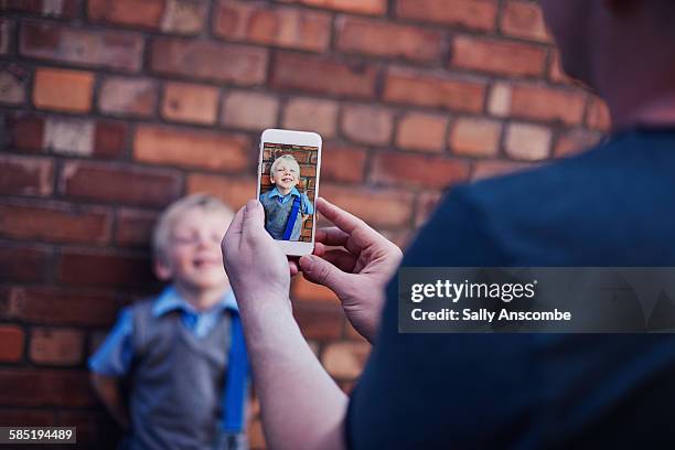 father at taking a photo of his son. - taking photo bildbanksfoton och bilder