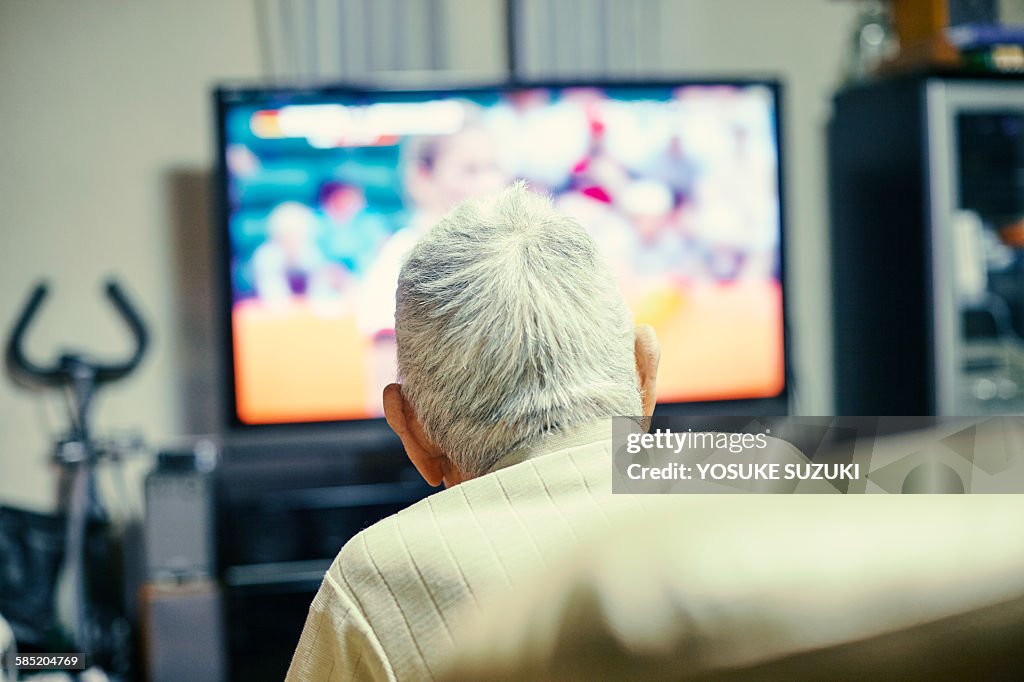 Old man watching TV