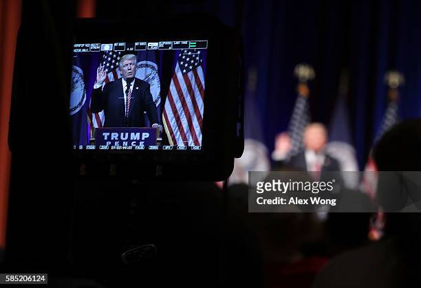 Republican presidential nominee Donald Trump is seen on a monitor as he speaks to voters during a campaign event at Briar Woods High School August 2,...
