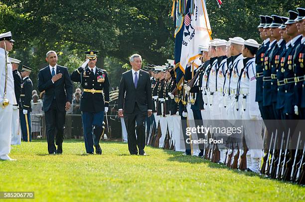 President Barack Obama and Prime Minister Lee Hsien Loong of Singapore review the troops during official welcoming ceremonies on the South Lawn of...