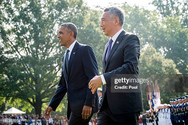 President Barack Obama and Prime Minister Lee Hsien Loong of Singapore make their way to greet guests during official welcoming ceremonies on the...