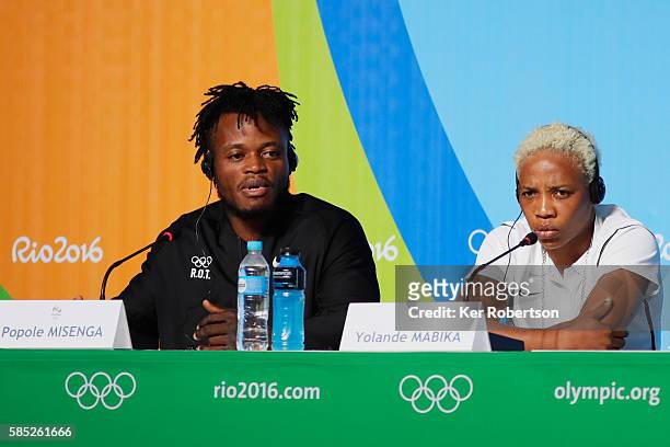 Judokas Popole Misenga and Yolande Mabika from the Democratic Republic of the Congo talk while attending a press conference given by the Olympic...