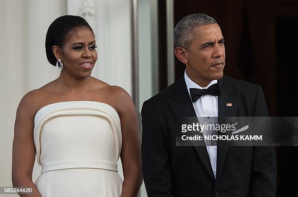 President Barack Obama and First Lady Michelle Obama await the arrival of Singapore's Prime Minister Lee Hsien Loong and his wife Ho Ching for a...