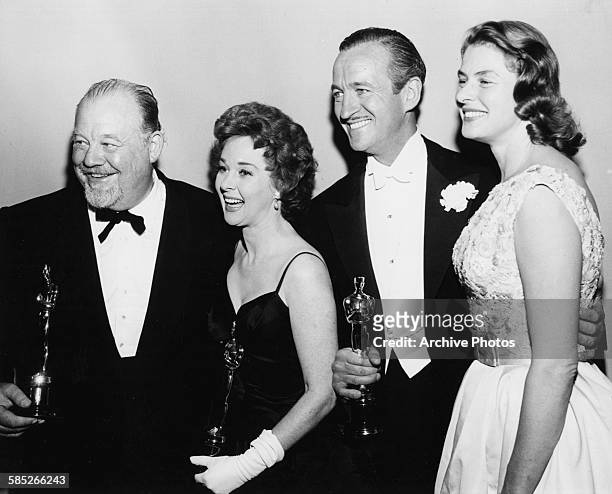 Actors Burl Ives, Susan Hayward and David Niven with their Oscars, with presenter Ingrid Bergman , at the 31st Academy Awards, Los Angeles, April 6th...