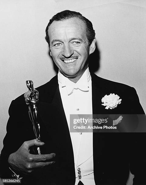 Actor David Niven holding his Best Actor Oscar for the film 'Separate Tables', at the 31st Academy Awards, Los Angeles, April 6th 1959.