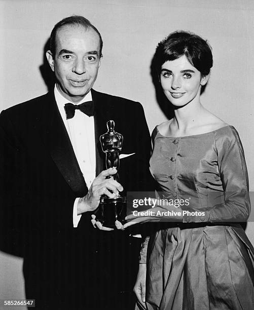 Director Vincente Minnelli holding his Oscar for the film 'Gigi', with presenter Millie Perkins, at the 31st Academy Awards, Los Angeles, April 6th...