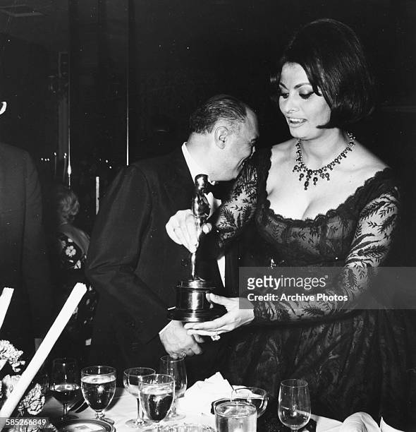 Actress Sophia Loren with her Best Actress Oscar for the film 'Two Women', with her husband Carlo Ponti, at a party held by Joe Levine where she...
