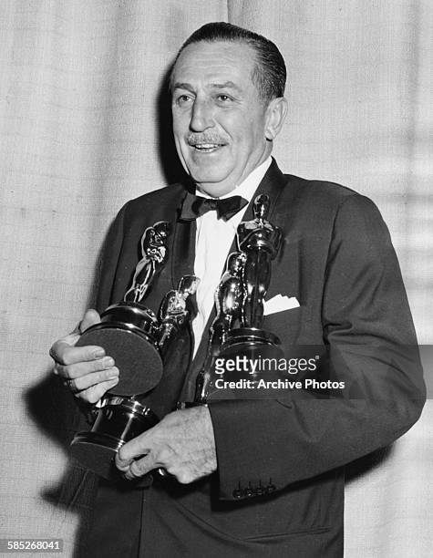 Film maker Walt Disney holding his four Oscars, for four different films, at the 26th Academy Awards, March 25th 1954.