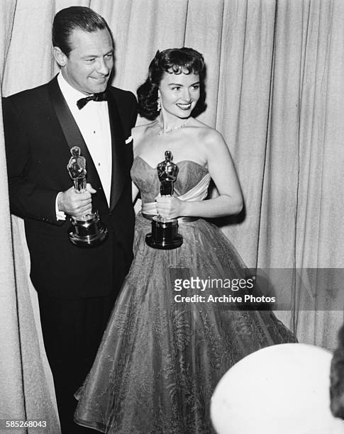 Actress Donna Reed holding her Oscar for the film 'From Here to Eternity', with actor William Holden holding his Oscar for the film 'Stalag 17', at...