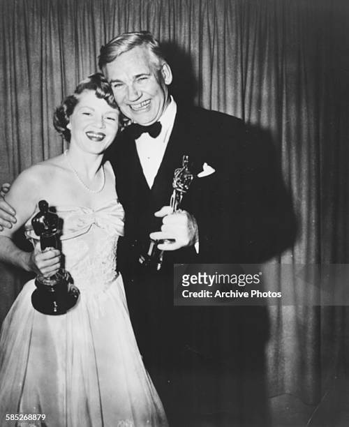 Actress Claire Trevor holding her Best Supporting Actress Oscar for the film 'Key Largo' with John Huston holding his Best Supporting Actor Oscar for...