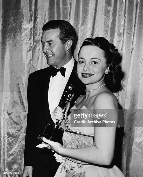 Actress Olivia de Havilland holding her Best Actress Oscar for the film 'To Each His Own', with presenter Ray Milland, at the 19th Academy Awards,...