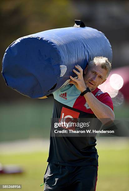 Strength coach Gareth Tong of Harlequins carry bags off the field during a team practice at San Francisco Golden Gate RFC on August 2, 2016 in San...