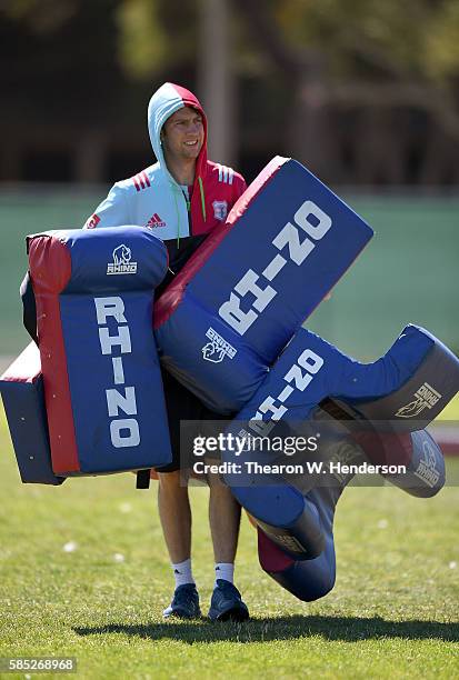 Physio Andy Reynolds of Harlequins carry bags off the field during a team practice at San Francisco Golden Gate RFC on August 2, 2016 in San...