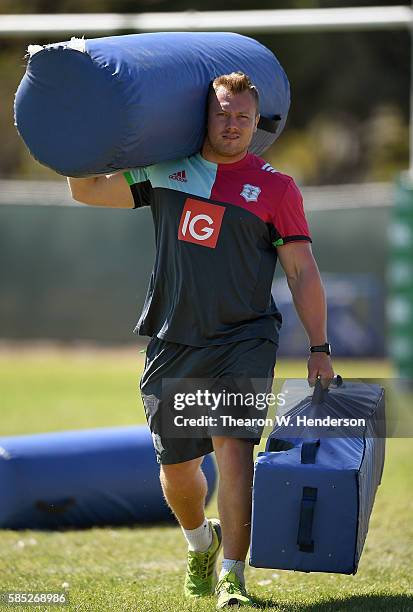 Strength coach Adam Bishop of Harlequins carry bags off the field during a team practice at San Francisco Golden Gate RFC on August 2, 2016 in San...