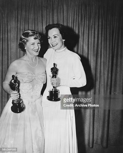 Actresses Jane Wyman and Claire Trevor holding their Oscars at the 21st Academy Awards, Los Angeles, March 24th 1949.