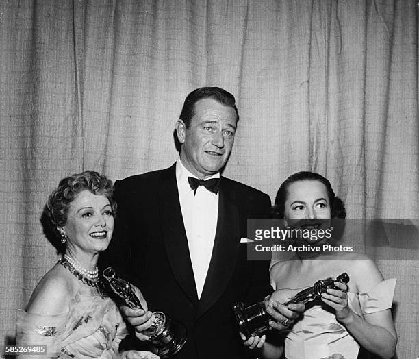 Actress Olivia de Havilland receiving her Best Actress Oscar, for the film 'The Heiress', from John Wayne, at the 22nd Academy Awards, Los Angeles,...