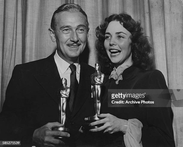 Actor Paul Lukas holding his Best Actor award for the film 'Watch on the Rhine' with actress Jennifer Jones holding her Best Actress award for the...