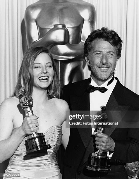 Actress Jody Foster holding Best Actress Oscar for the film 'The Accused', with actor Dustin Hoffman holding his Best Actor Oscar for the film 'Rain...