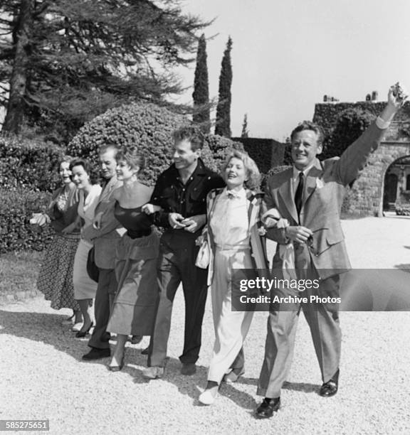 Actors Van Johnson, S Miranda, Jean Pierre Aumont, Brigitte Bardot, M Pagnol, N Gray and Olivia de Havilland, arm in arm at the Cannes Film Festival,...