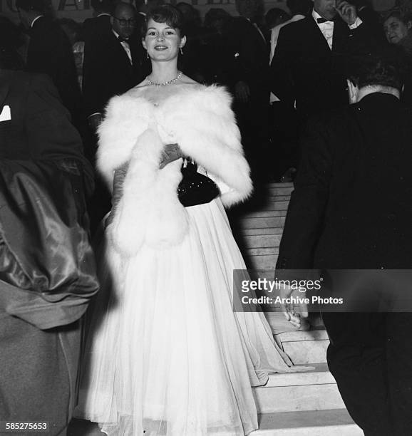 Actress Brigitte Bardot wearing a ball gown and fur stole as she attends the Cannes Film Festival, April 20th 1953.