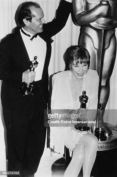 Actors Jack Nicholson and Shirley MacLaine joking around whith their Oscar statuettes, which they both won for the film 'Terms of Endearment', at the...