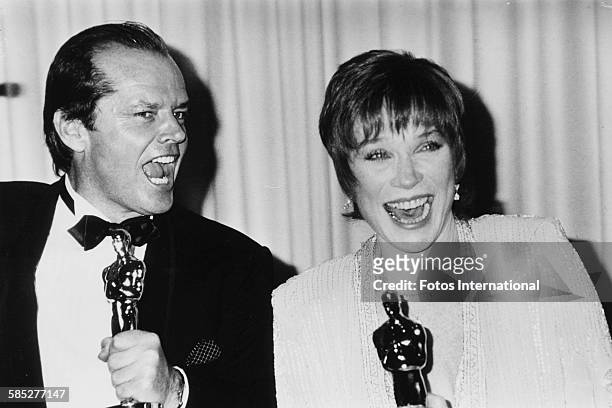 Actors Jack Nicholson and Shirley MacLaine joking around with their Oscar statuettes, which they both won for the film 'Terms of Endearment', at the...